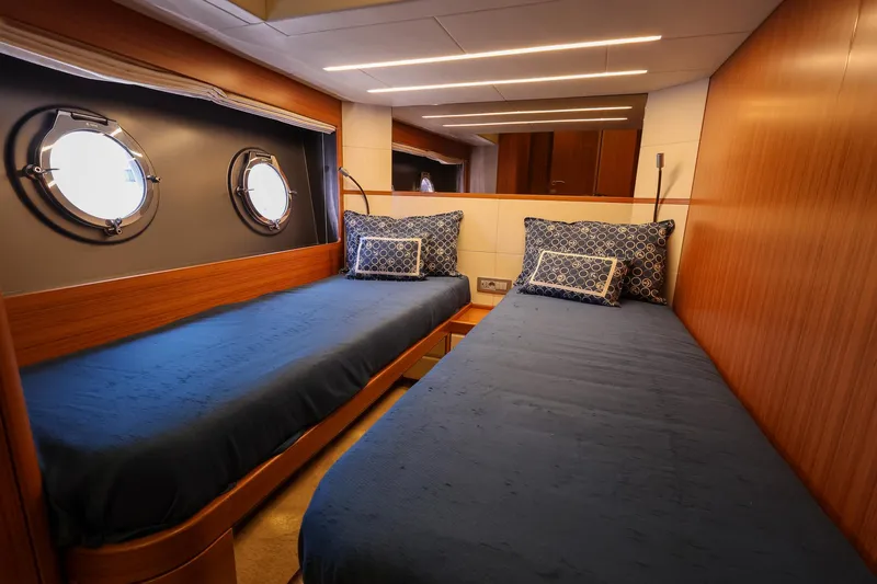 Mas Que Nada Yacht Photos Pics Luxurious twin cabin in 2021 Greenline OceanClass 68 yacht with porthole windows.