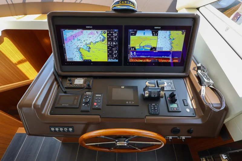Mas Que Nada Yacht Photos Pics Helm station of 2021 Greenline OceanClass 68 yacht with navigation screens and controls.