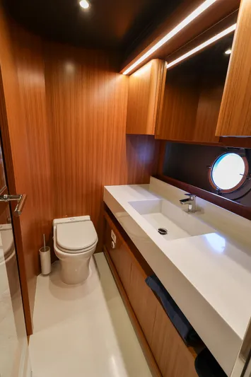 Mas Que Nada Yacht Photos Pics Luxurious bathroom in 2021 Greenline OceanClass 68 yacht with modern fixtures and wood accents.