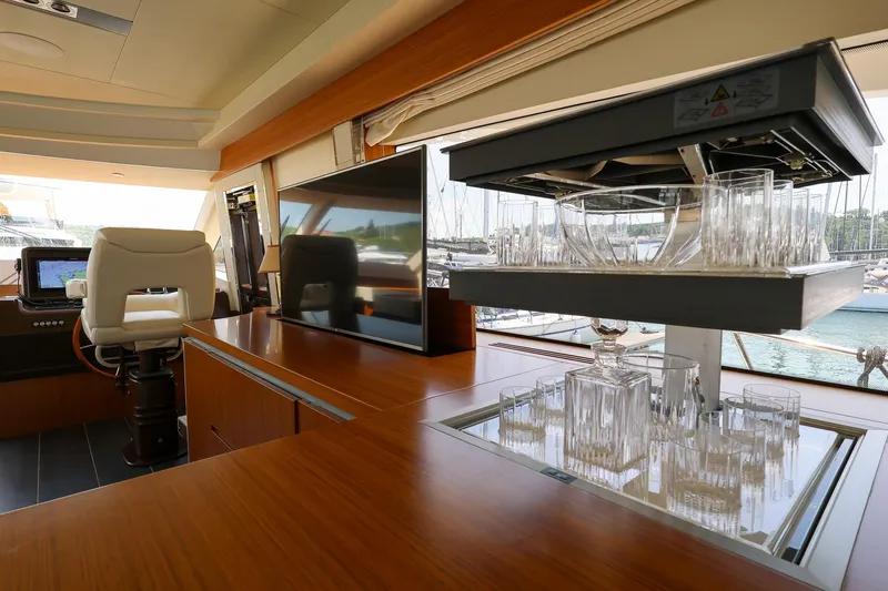 Mas Que Nada Yacht Photos Pics Luxurious interior of 2021 Greenline OceanClass 68 yacht with modern amenities and glassware.