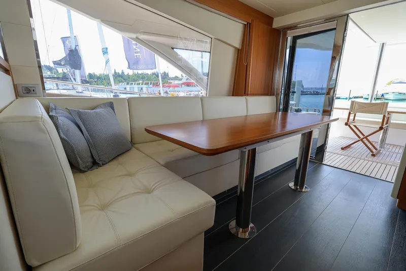 Mas Que Nada Yacht Photos Pics Luxurious interior of 2021 Greenline OceanClass 68 yacht with elegant seating and wooden table.
