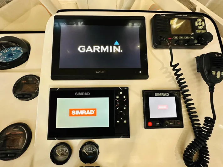  Yacht Photos Pics 2003 Intrepid 322 Cuddy dashboard with Garmin and Simrad navigation systems.