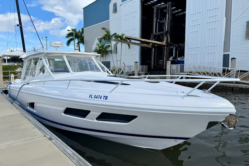  Yacht Photos Pics 2022 Intrepid 409 Valor boat docked at marina, featuring sleek white design.