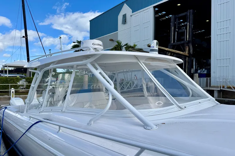  Yacht Photos Pics 2022 Intrepid 409 Valor boat docked near a marina with clear blue skies.