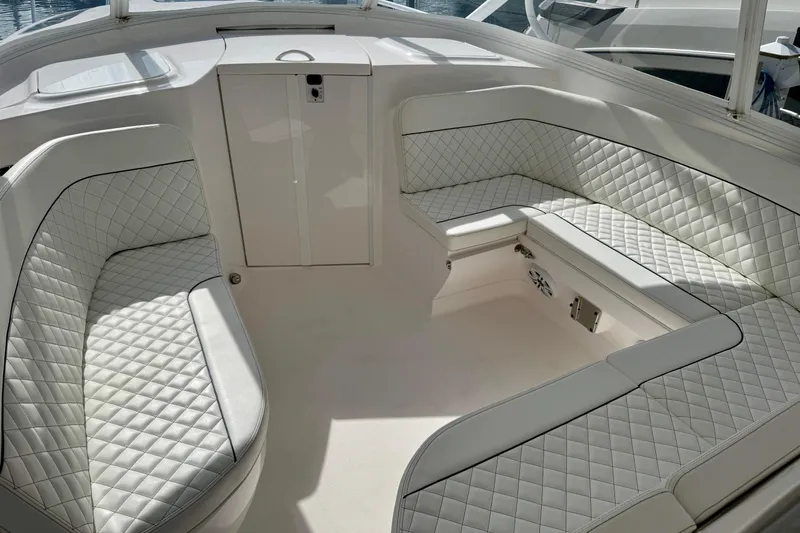  Yacht Photos Pics Luxurious seating area on 2022 Intrepid 409 Valor boat with quilted white upholstery.