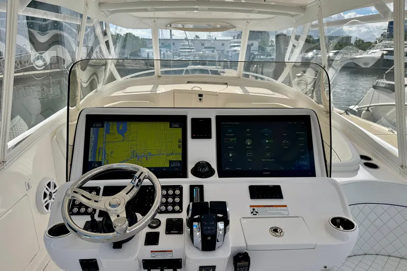  Yacht Photos Pics 2022 Intrepid 409 Valor boat dashboard with navigation screens and steering wheel.