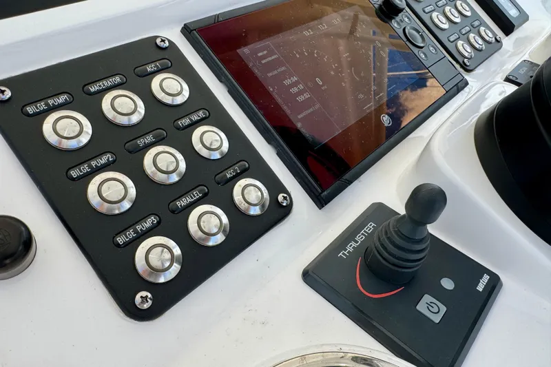  Yacht Photos Pics Control panel of 2022 Intrepid 409 Valor boat with buttons and joystick.