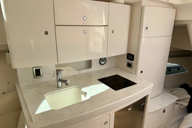  Yacht Photos Pics 2022 Intrepid 409 Valor yacht interior with modern kitchenette and sleek cabinetry.