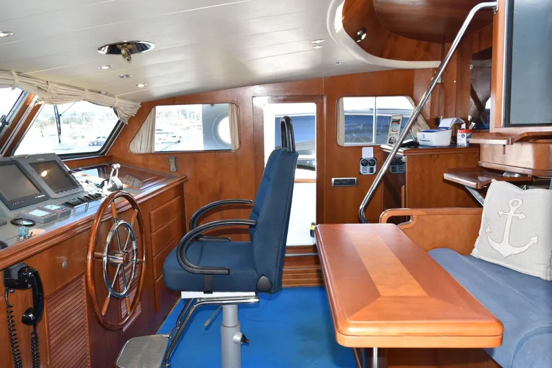 Alieva Yacht Photos Pics Interior of 2010 Joubert-Nivelt ALIEVA 60 yacht with wooden helm and seating area.