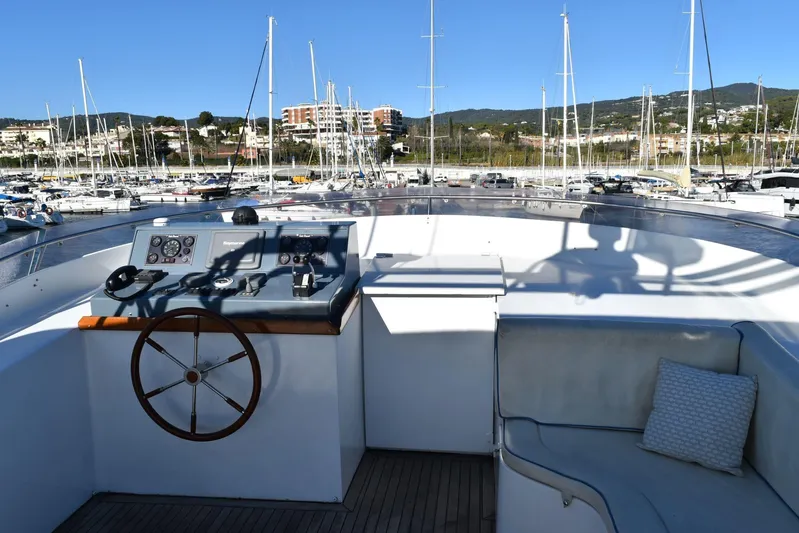 Alieva Yacht Photos Pics Helm of 2010 Joubert-Nivelt ALIEVA 60 yacht in marina, featuring steering wheel and controls.