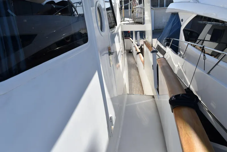 Alieva Yacht Photos Pics Side deck view of 2010 Joubert-Nivelt ALIEVA 60 yacht with wooden handrails.