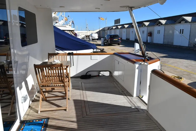 Alieva Yacht Photos Pics Deck of 2010 Joubert-Nivelt ALIEVA 60 yacht with wooden furniture and marina view.