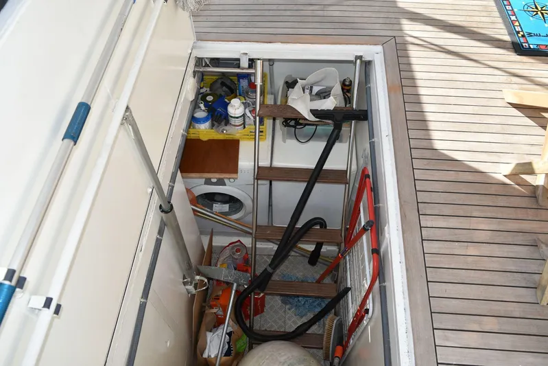 Alieva Yacht Photos Pics Storage compartment on Joubert-Nivelt ALIEVA 60 yacht, featuring cleaning supplies and equipment.