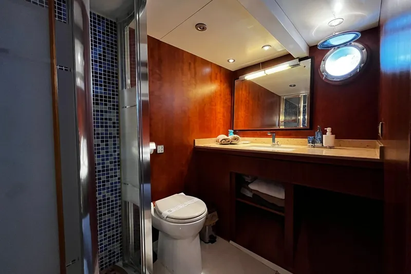 Alieva Yacht Photos Pics Luxurious bathroom in 2010 Joubert-Nivelt ALIEVA 60 yacht with wood paneling and modern fixtures.