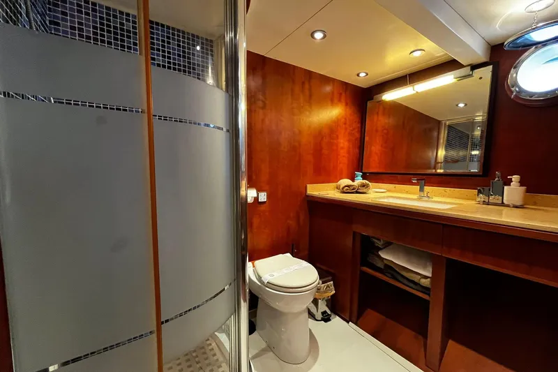 Alieva Yacht Photos Pics Luxurious bathroom in 2010 Joubert-Nivelt ALIEVA 60 yacht with modern fixtures and wooden cabinetry.