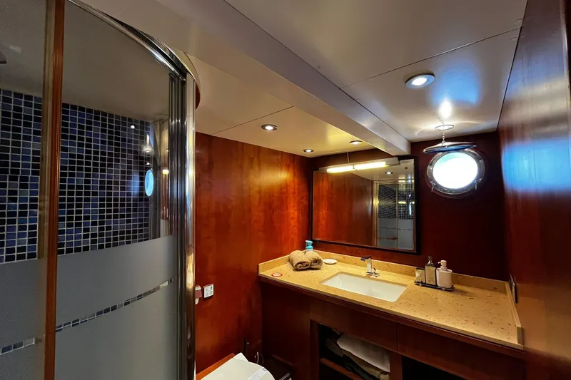 Alieva Yacht Photos Pics Luxurious bathroom in 2010 Joubert-Nivelt ALIEVA 60 yacht with modern fixtures and porthole window.
