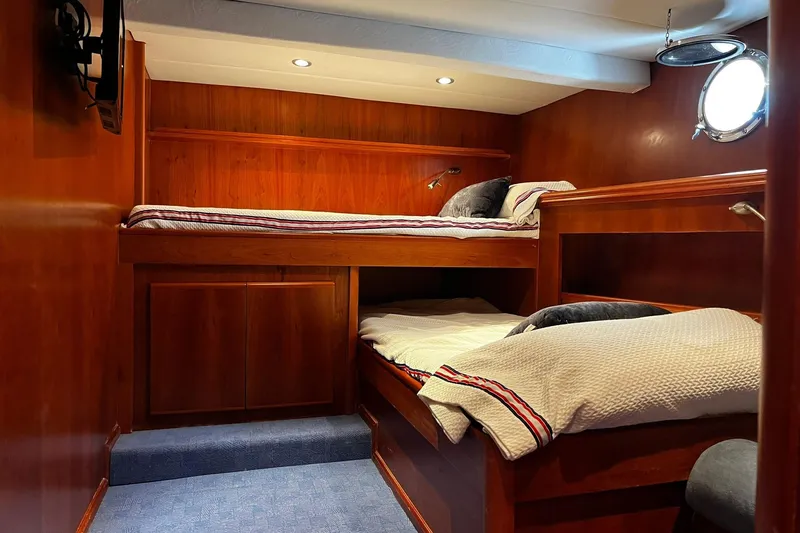 Alieva Yacht Photos Pics Cozy cabin interior of 2010 Joubert-Nivelt ALIEVA 60 yacht with wooden bunk beds.