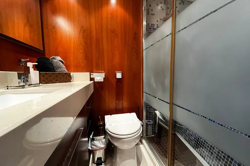 Alieva Yacht Photos Pics Luxurious bathroom in 2010 Joubert-Nivelt ALIEVA 60 yacht with modern fixtures and wood paneling.