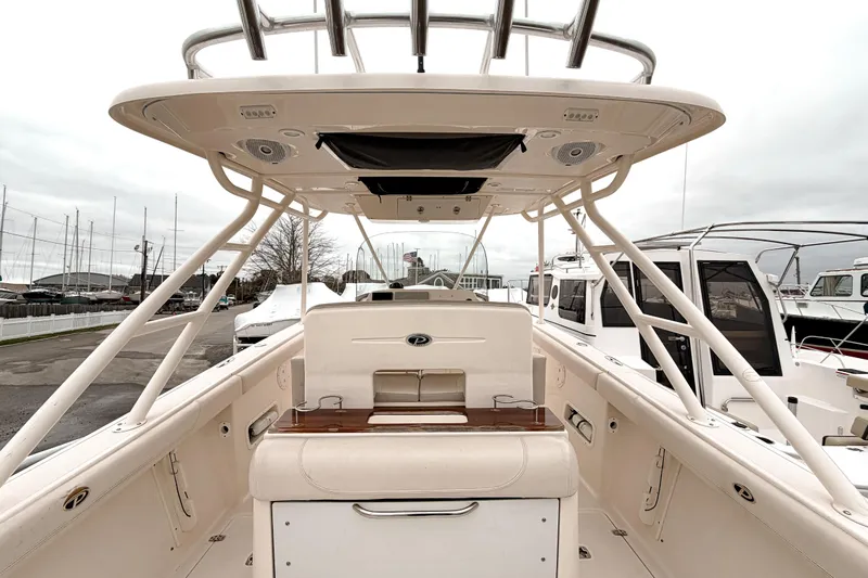  Yacht Photos Pics 2014 Pursuit S 280 Sport boat interior, featuring helm and seating area at a marina.