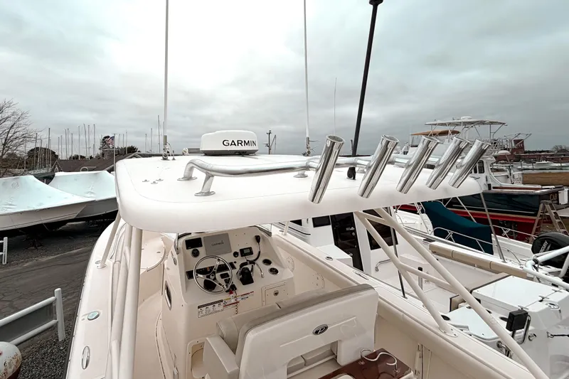  Yacht Photos Pics 2014 Pursuit S 280 Sport boat with Garmin equipment, docked under cloudy skies.