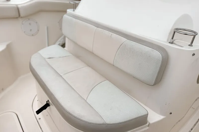  Yacht Photos Pics 2014 Pursuit S 280 Sport boat seating with cup holder and white upholstery.