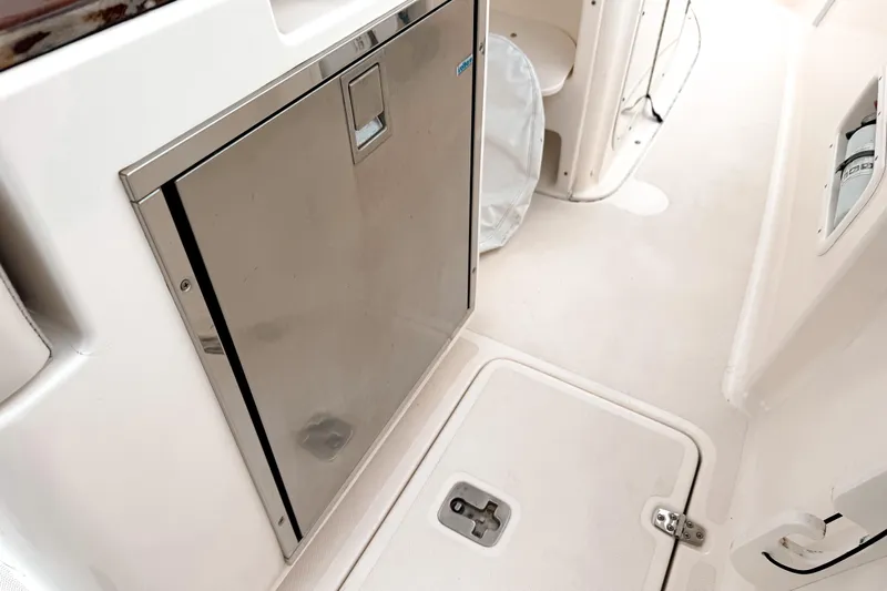  Yacht Photos Pics 2014 Pursuit S 280 Sport boat interior with stainless steel door and storage compartments.