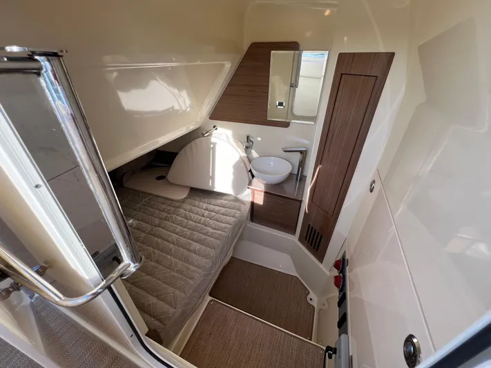 Sea Senora Yacht Photos Pics 2022 Chris-Craft Catalina 30 cabin interior with bed, sink, and wooden accents.