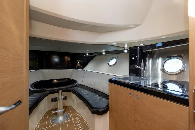  Yacht Photos Pics Luxurious interior of 2009 Sessa Marine Key Largo 36 yacht with seating and kitchenette.