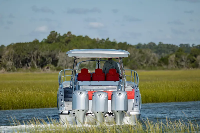  Yacht Photos Pics 2009 Sessa Marine Key Largo 36 boat cruising through lush green waterways.