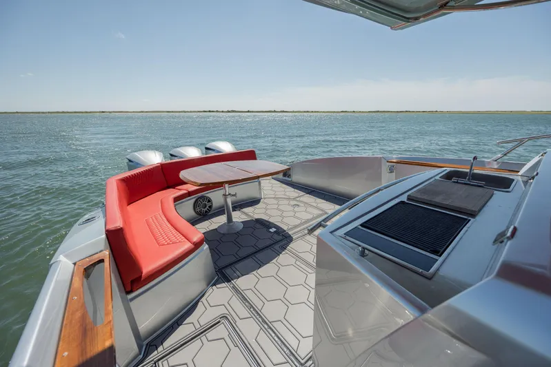  Yacht Photos Pics 2009 Sessa Marine Key Largo 36 boat with red seating and outdoor grill on open water.