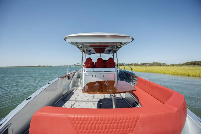  Yacht Photos Pics 2009 Sessa Marine Key Largo 36 boat with red seating and table on calm water.