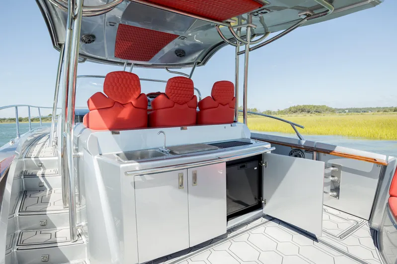  Yacht Photos Pics 2009 Sessa Marine Key Largo 36 boat interior with red seats and kitchenette.