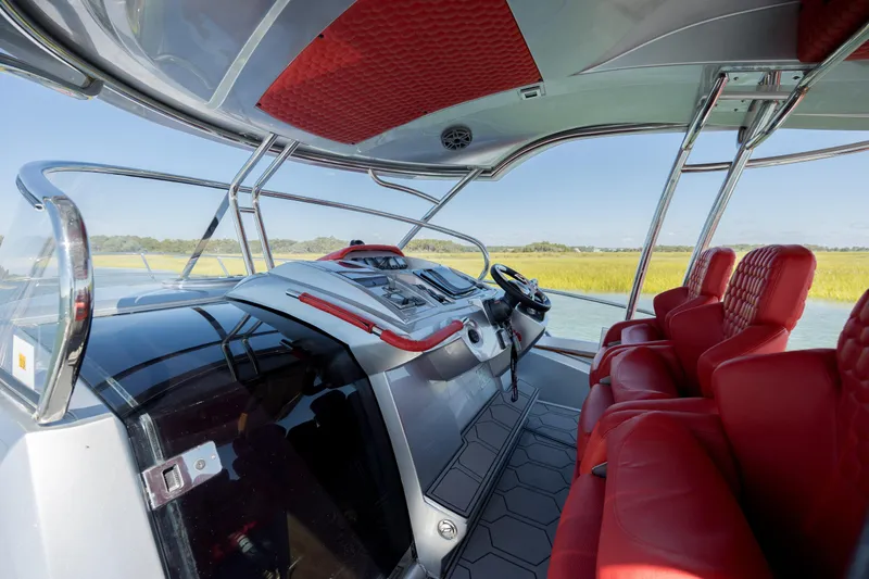  Yacht Photos Pics Interior of 2009 Sessa Marine Key Largo 36 with red seating and modern controls.