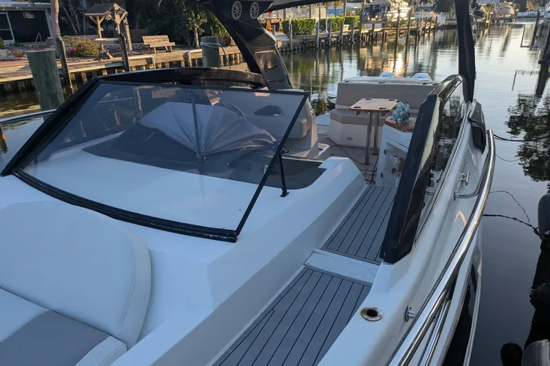 Mbvip Yacht Photos Pics 2023 NX Boats 340 Sport Coupe docked in a serene marina setting.