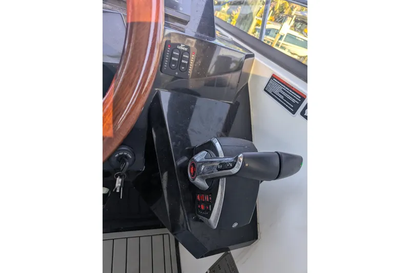 Mbvip Yacht Photos Pics Control panel of 2023 NX Boats 340 Sport Coupe with steering wheel and throttle lever.