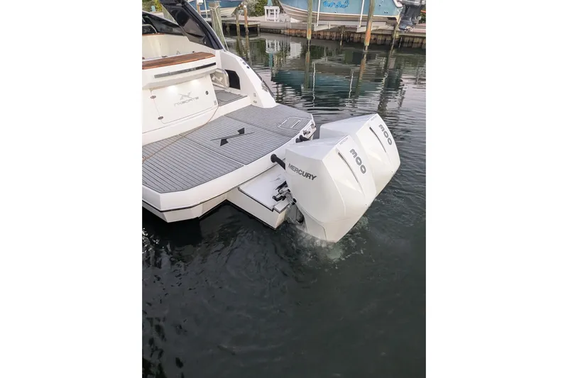 Mbvip Yacht Photos Pics 2023 NX Boats 340 Sport Coupe with twin Mercury outboard engines in marina.