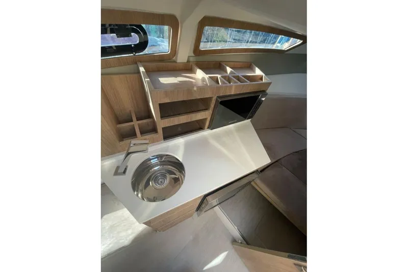 Mbvip Yacht Photos Pics Interior of 2023 NX Boats 340 Sport Coupe featuring modern kitchenette design.