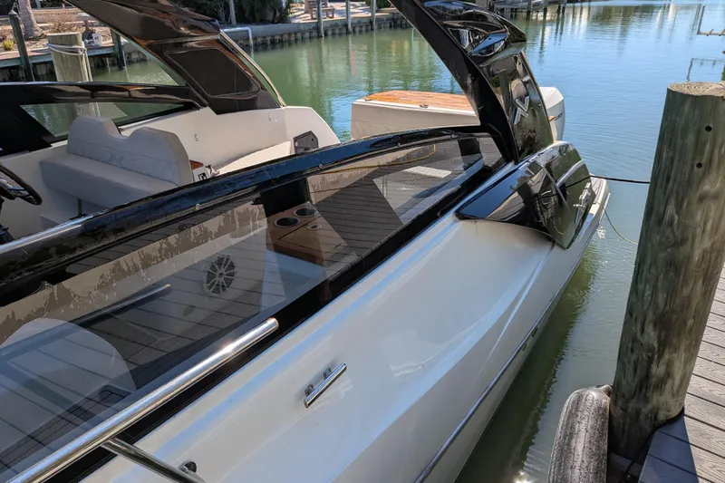 Mbvip Yacht Photos Pics 2023 NX Boats 340 Sport Coupe docked, showcasing sleek design and luxurious interior.