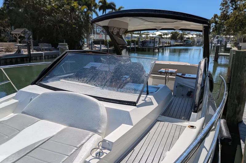 Mbvip Yacht Photos Pics 2023 NX Boats 340 Sport Coupe docked, showcasing sleek design and spacious deck.