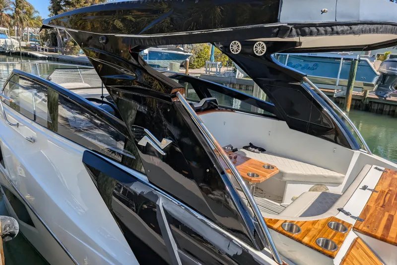 Mbvip Yacht Photos Pics 2023 NX Boats 340 Sport Coupe, sleek design, luxurious interior, docked at marina.