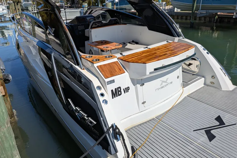Mbvip Yacht Photos Pics 2023 NX Boats 340 Sport Coupe docked, showcasing sleek design and luxurious features.