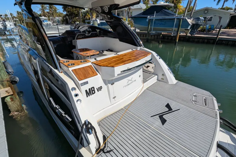 Mbvip Yacht Photos Pics 2023 NX Boats 340 Sport Coupe docked, featuring sleek design and spacious deck.