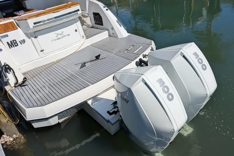Mbvip Yacht Photos Pics 2023 NX Boats 340 Sport Coupe with dual Mercury 300 engines docked on water.