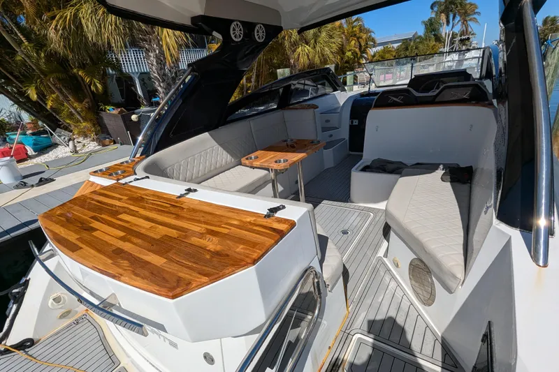 Mbvip Yacht Photos Pics 2023 NX Boats 340 Sport Coupe interior with elegant seating and wooden accents.