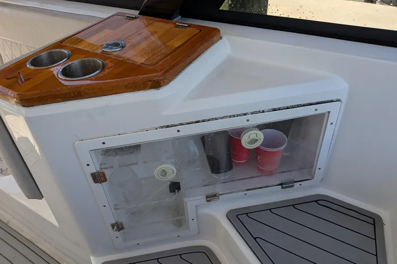 Mbvip Yacht Photos Pics 2023 NX Boats 340 Sport Coupe interior with cup holders and storage compartment.