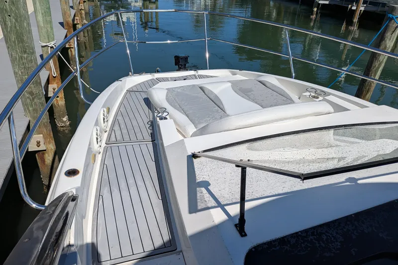 Mbvip Yacht Photos Pics 2023 NX Boats 340 Sport Coupe, sleek deck view at marina.