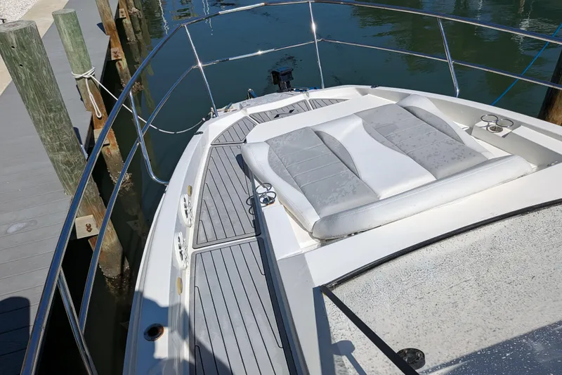 Mbvip Yacht Photos Pics 2023 NX Boats 340 Sport Coupe with sunpad, docked at marina.