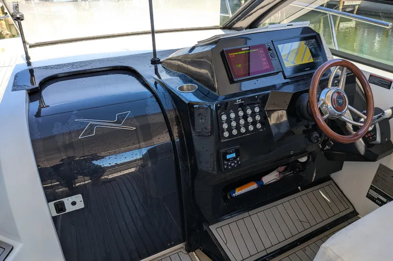 Mbvip Yacht Photos Pics 2023 NX Boats 340 Sport Coupe helm with modern controls and navigation displays.