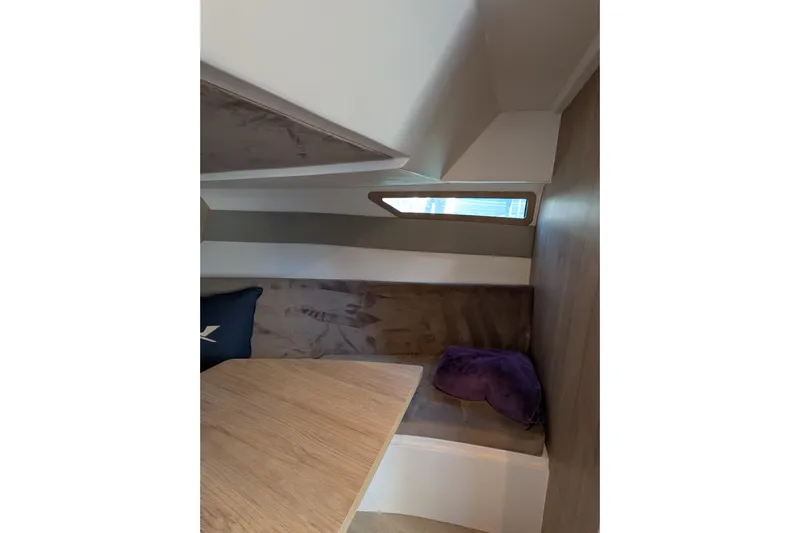 Mbvip Yacht Photos Pics Interior cabin of 2023 NX Boats 340 Sport Coupe, featuring seating and a window.