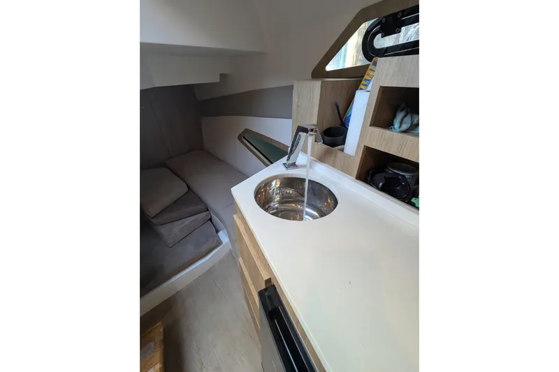 Mbvip Yacht Photos Pics Interior of 2023 NX Boats 340 Sport Coupe with sink and seating area.